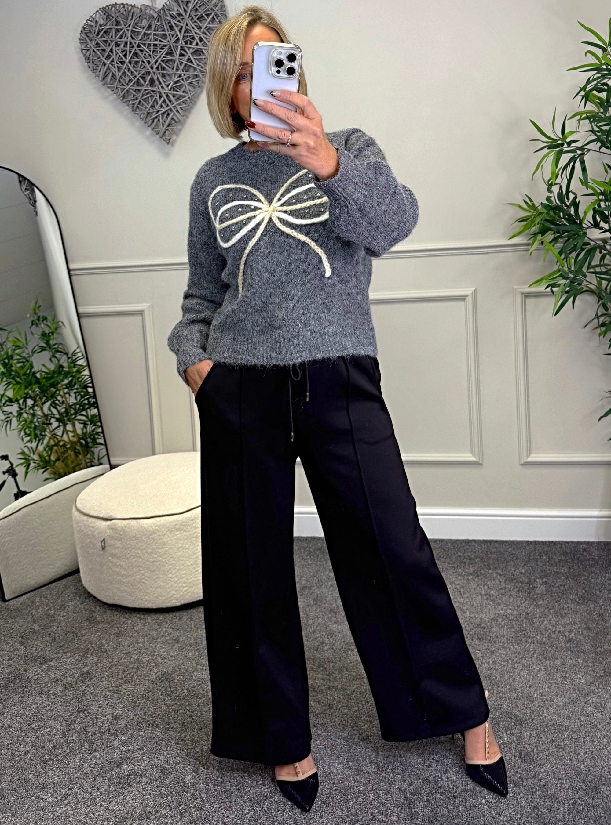 Model wearing bow and gem jumper in grey available at www.susiesboutique.co.uk