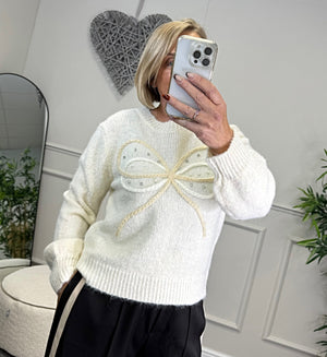 Model wearing bow and gem jumper in white available at www.susiesboutique.co.uk