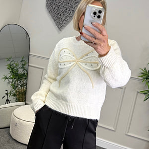 Model wearing bow and gem jumper in white available at www.susiesboutique.co.uk