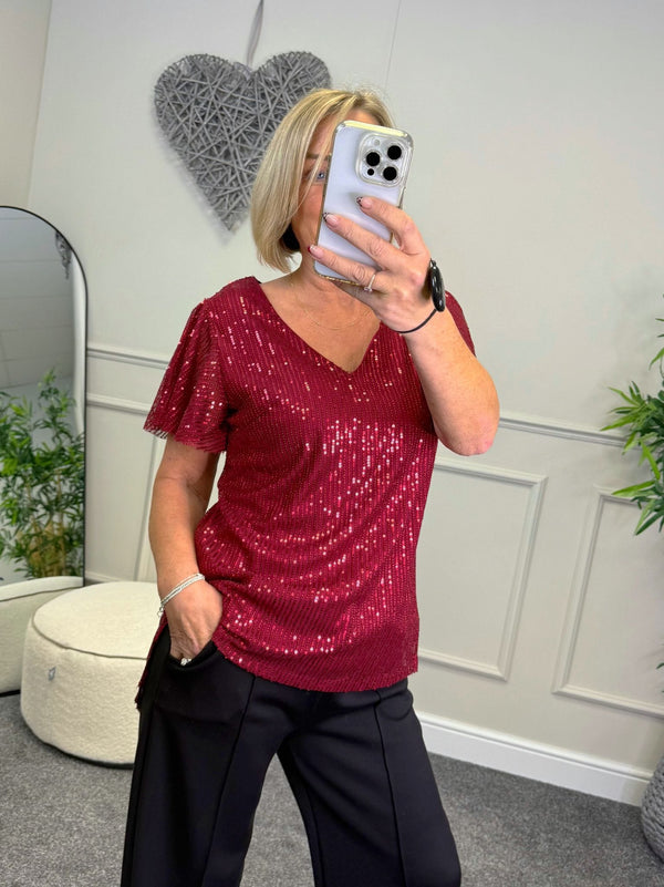 Susie wearing sequin v-neck top available at susiesboutique.co.uk